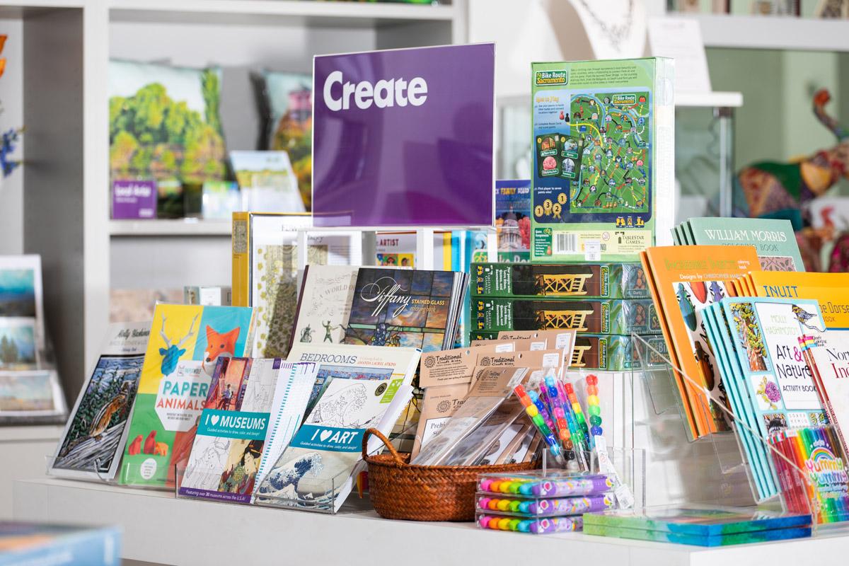 A table of various adult coloring books and art supplies in the Museum store.